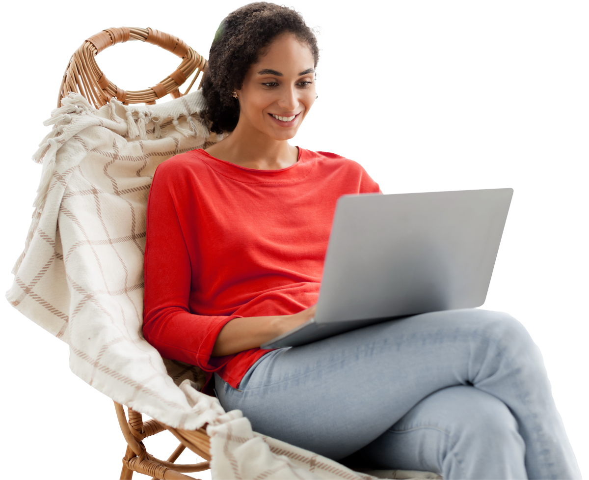 Woman sitting in a chair working on a laptop